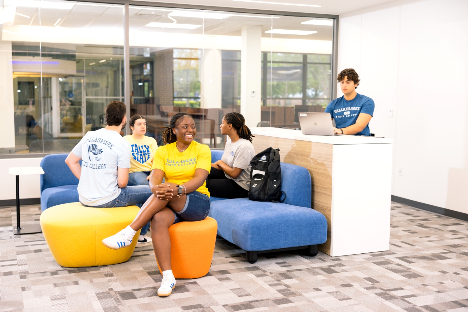 Students sitting in Innovation Hub lounge area, laughing and chatting.