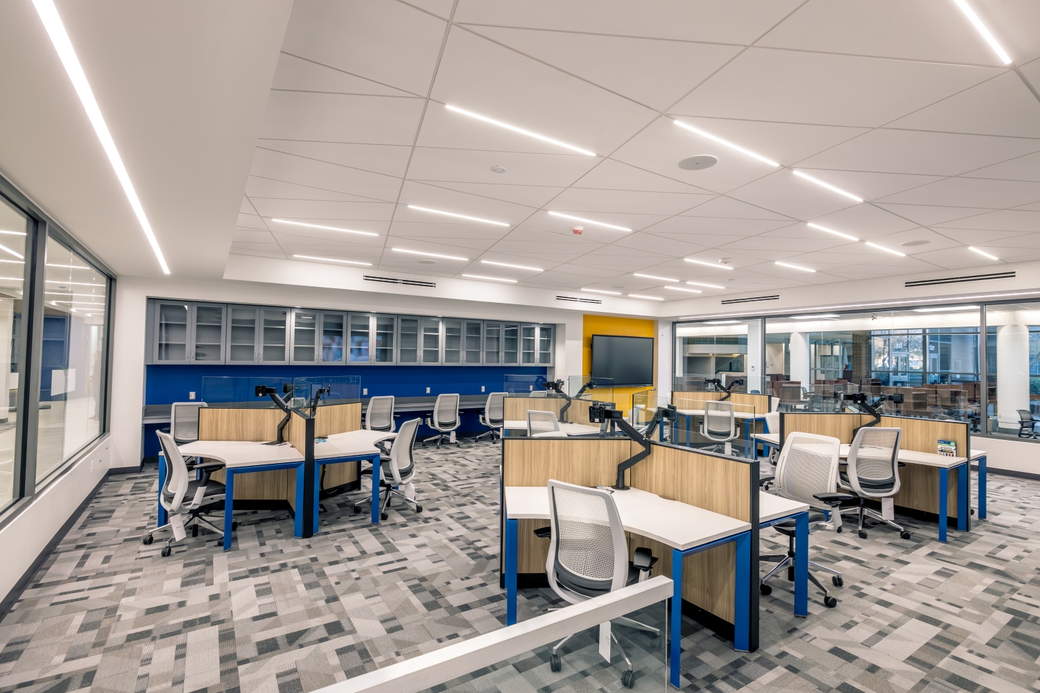 Empty computer classroom with multiple stations for students.
