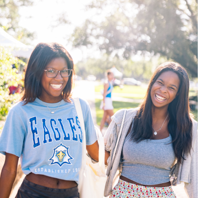 Two TSC students at convocation, smiling for the camera.