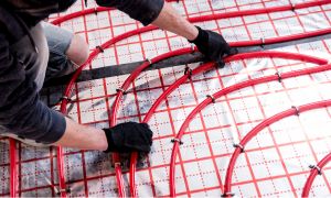 Plumber laying down red lines.
